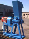 <H2>Durl GP 12/9 Granulator</H2>
<UL><LI>Throat opening : 300mm x 225mm</LI>
<LI>Two-bladed rotor - blades inclined to produce scissors action</LI>
<LI>Heavy duty outboard bearings</LI>
<LI>Casing is made of SG Iron, split into two halves, hinged and dowelled for precise location</LI>
<LI>Rotor is driven directly by a four pole 15Kw AC motor via a flywheel for inertia and a coupling</LI>
<LI>Feed hopper is fabricated of steel - can be made to suit particular product, including bottles</LI>
<LI>Feed hopper can be fitted with an air plunger system to handle bottles and light objects</LI>
<LI>The discharge hopper is circular with a rib for bag attachment, or a screw conveyor, belt conveyor, vibrator feeder or air transport system can be used.</LI>
<LI>The granulator can be equipped for simultaneously washing and granulating (SA Pat. APPLN 2003/5636) which obviates the necessity for a separate washing plant.</LI>
<LI>Screen size to suit the application and size of granule required.</LI></UL>